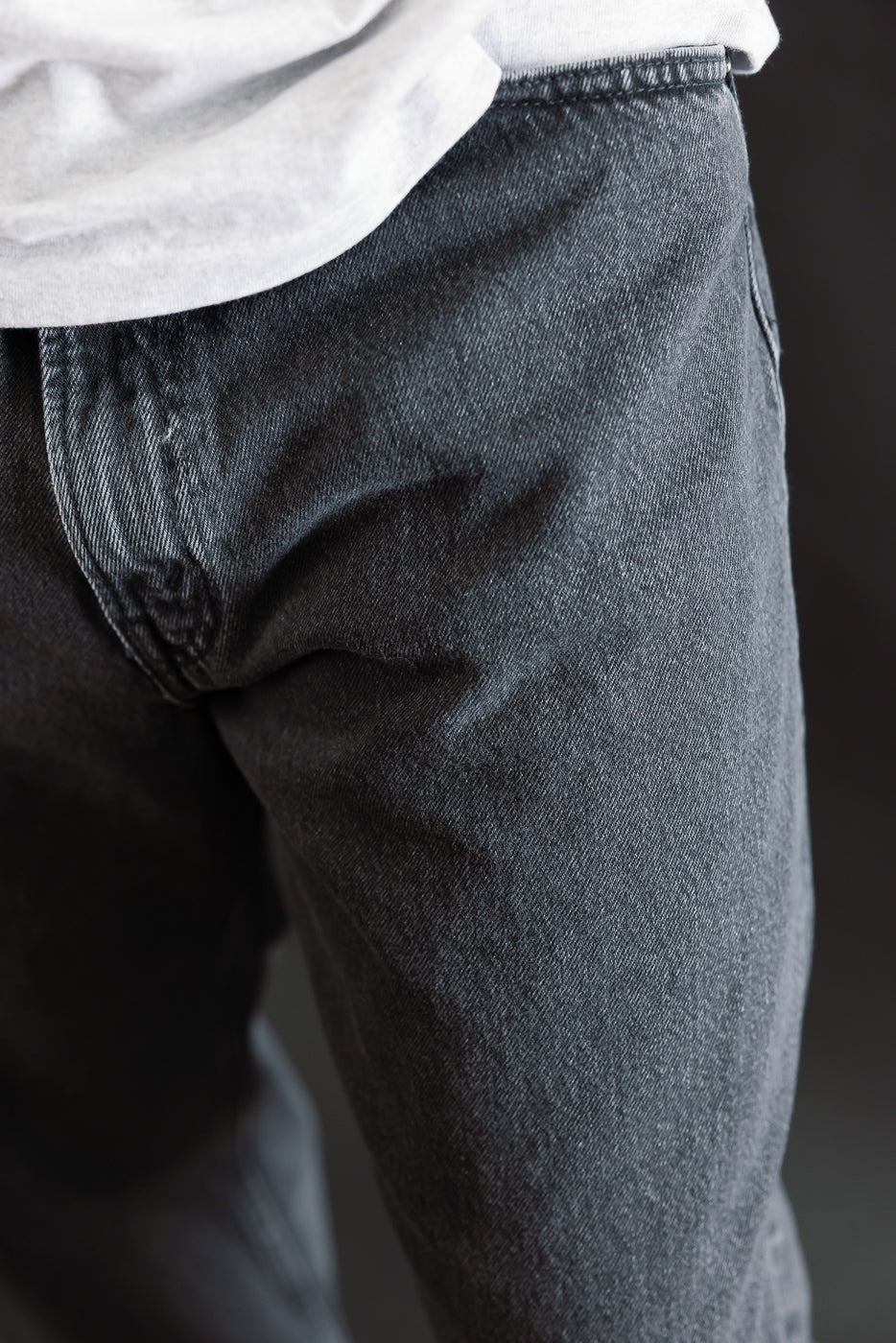 Close-up of the 01-1010W-D61S - 101 Dad’s Fit Denim - 90s Black Stone, showcasing the charcoal-gray stone-washed denim with relaxed fit, front pocket seam, beltline, and zipper fly.