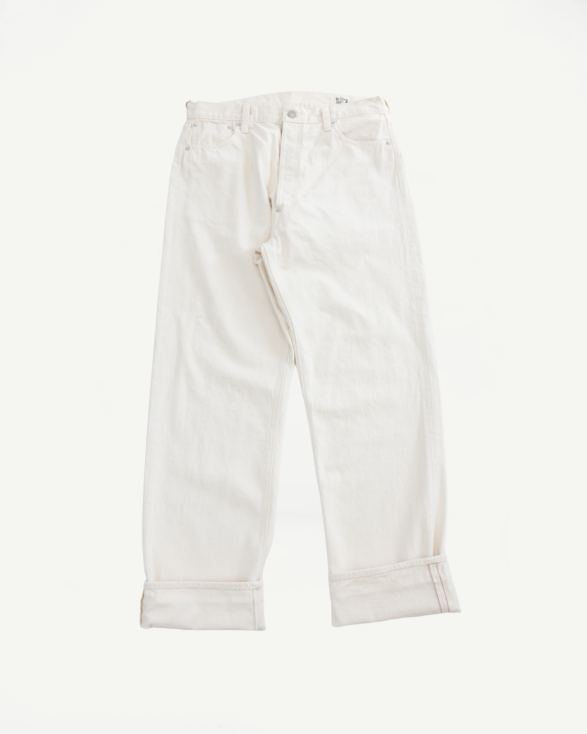 01-1011-66 - Grand Dad's Fit Kinari Selvedge - Ecru jeans are laid flat, showcasing rolled cuffs and a generous straight leg in undyed cotton, with period-correct details like a cinch-back waistband and engraved buttons.