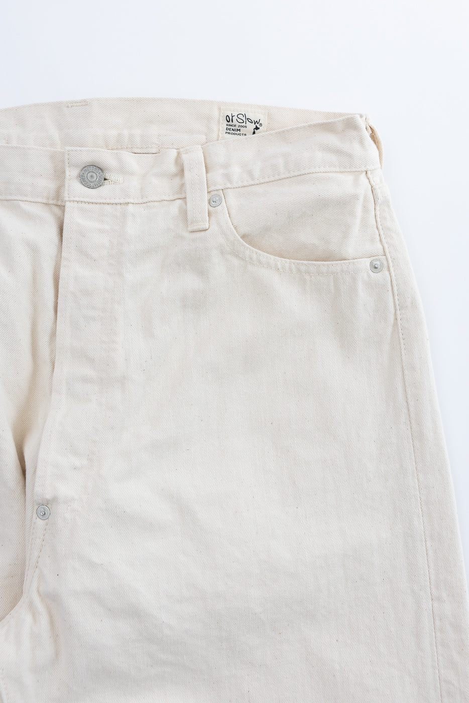 orSlow's Grand Dad's Fit Kinari Selvedge - Ecru denim trousers feature a cinch-back waistband, metal button-fly, and selvedge coin pocket, embodying 1930s American workwear with undyed, organic-textured fabric.