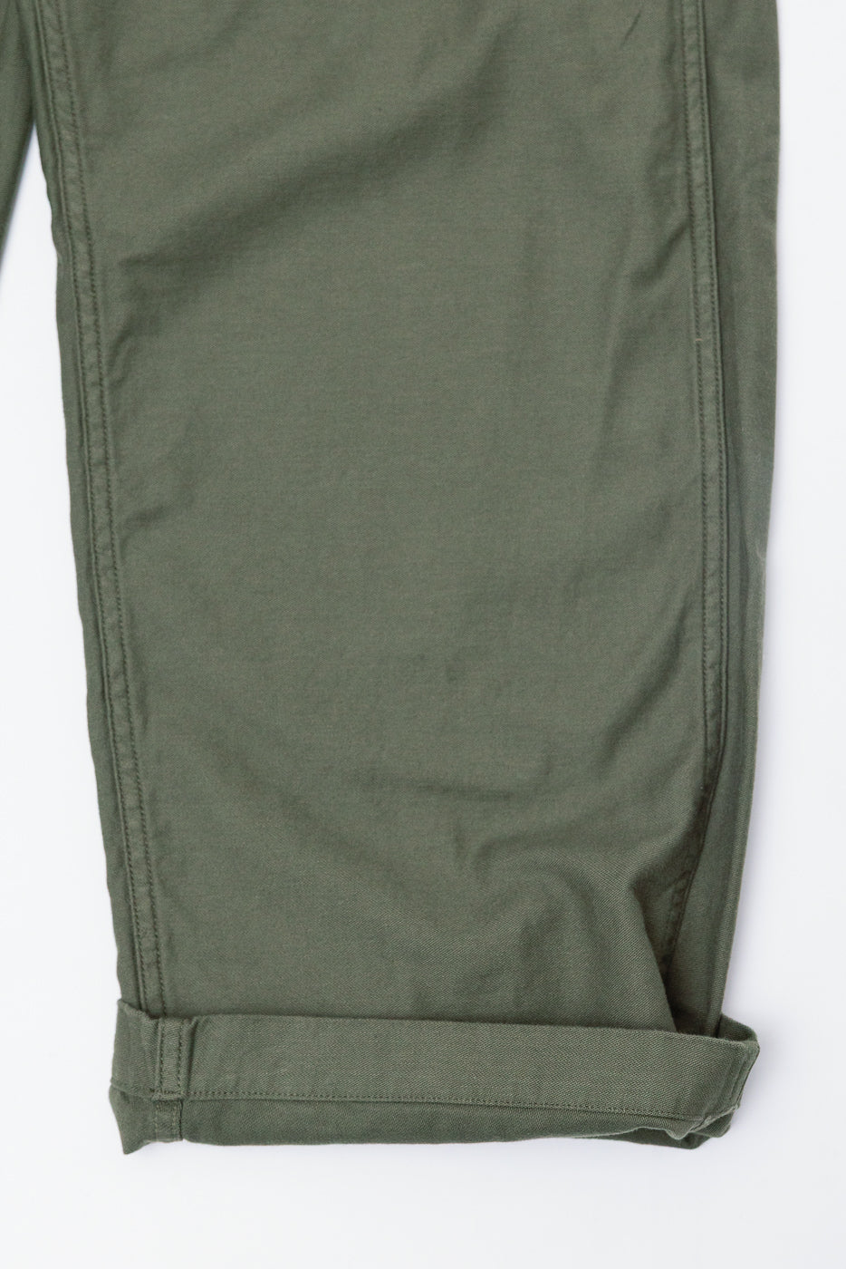 Close-up of orSlow dark olive New Yorker pants cuff, showing side leg and fabric texture