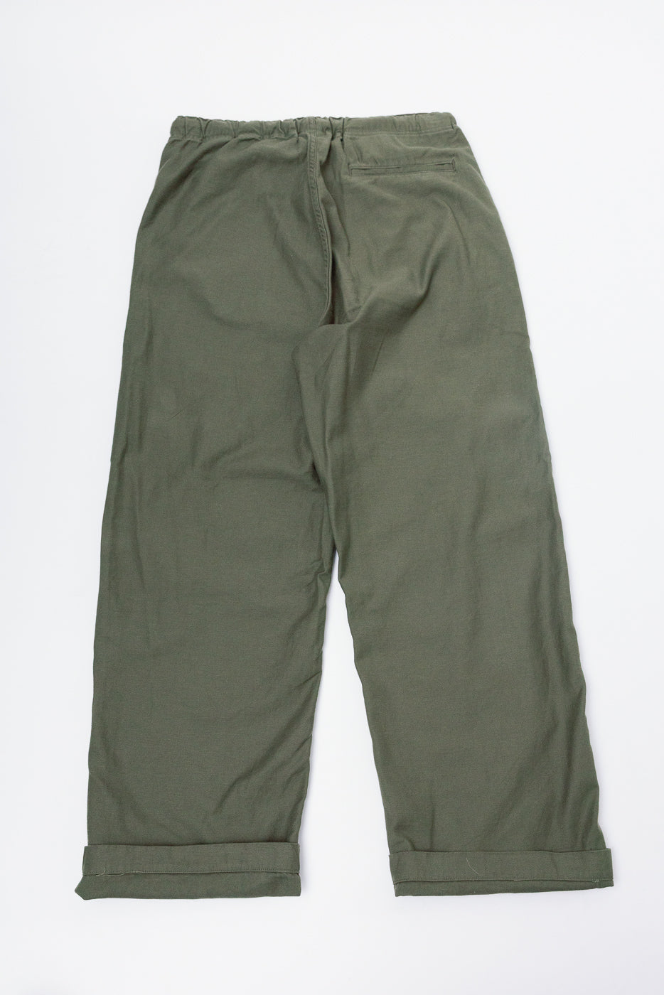 Flat lay of orSlow New Yorker pants wide fit in dark olive, back view, elastic waistband, single rear pocket