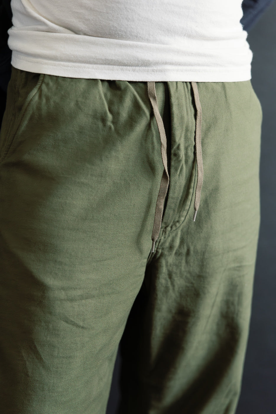 Close-up front view of orSlow New Yorker pants in dark olive on male model 5'9
