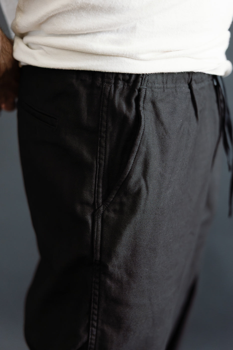 Close-up of front right side of orSlow New Yorker Pants in black, worn by 5'9