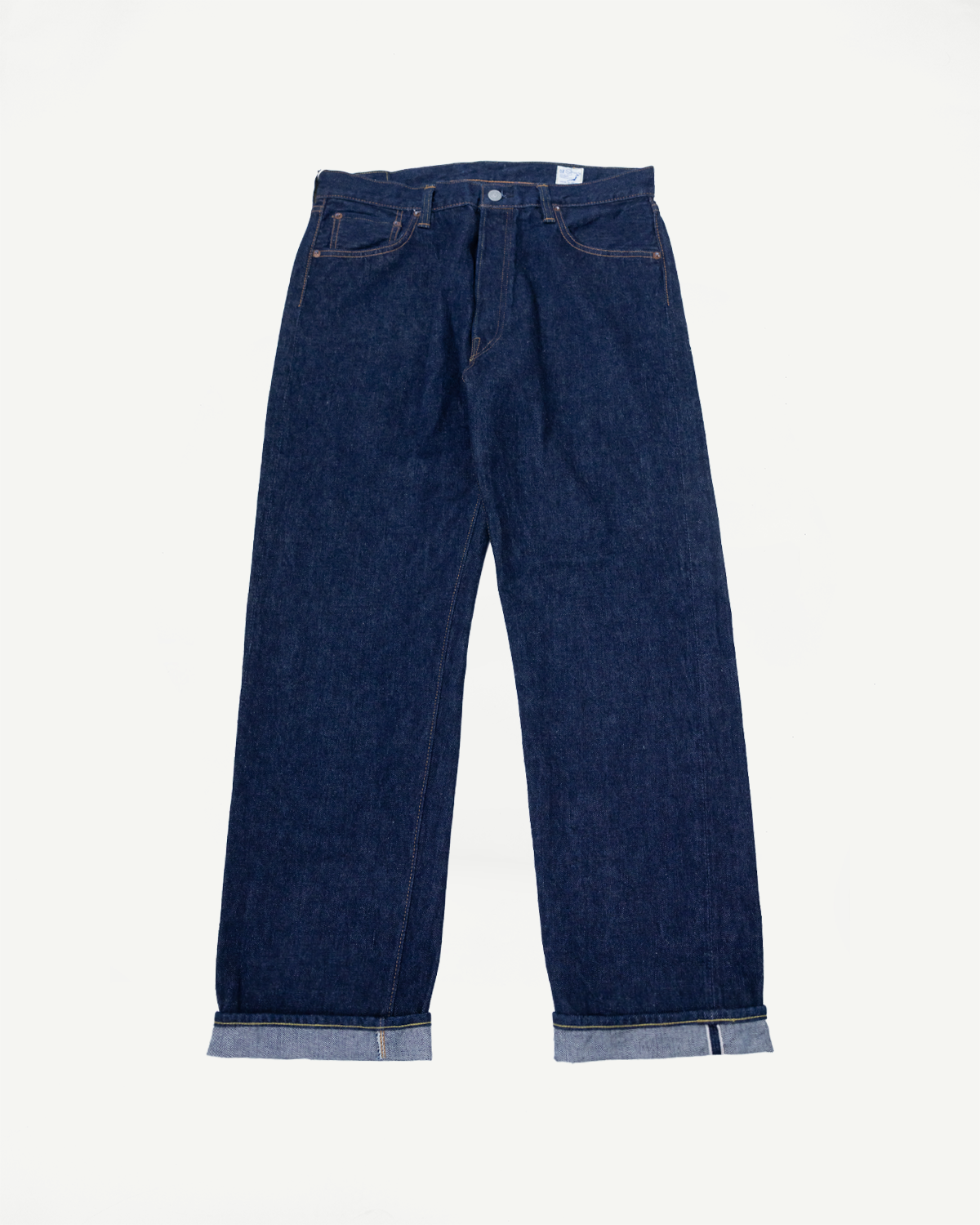 Flat lay of orSlow 1950s selvedge denim jeans, front view with visible cuffs and button fly.