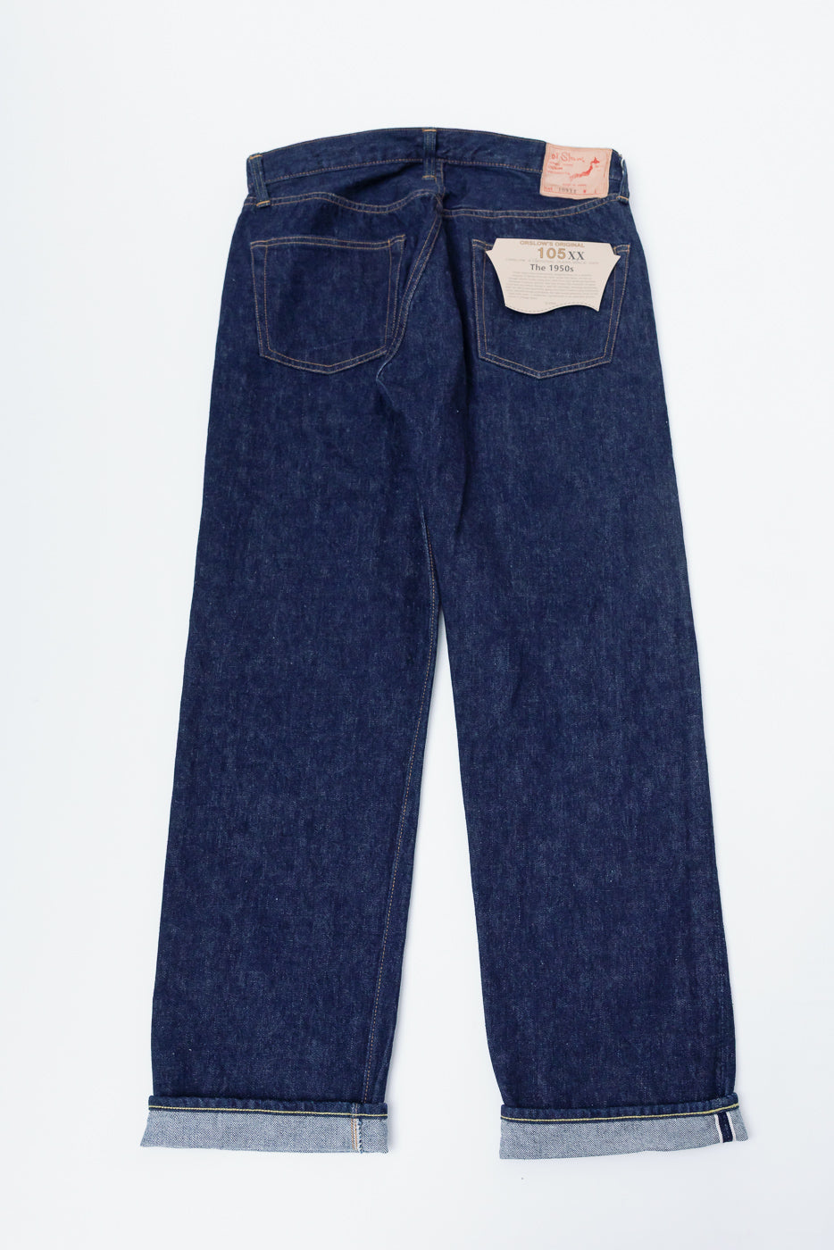 Flat lay rear view of Orslow 1050XX The 1950s selvedge denim jeans, showing back pockets and cuff details.