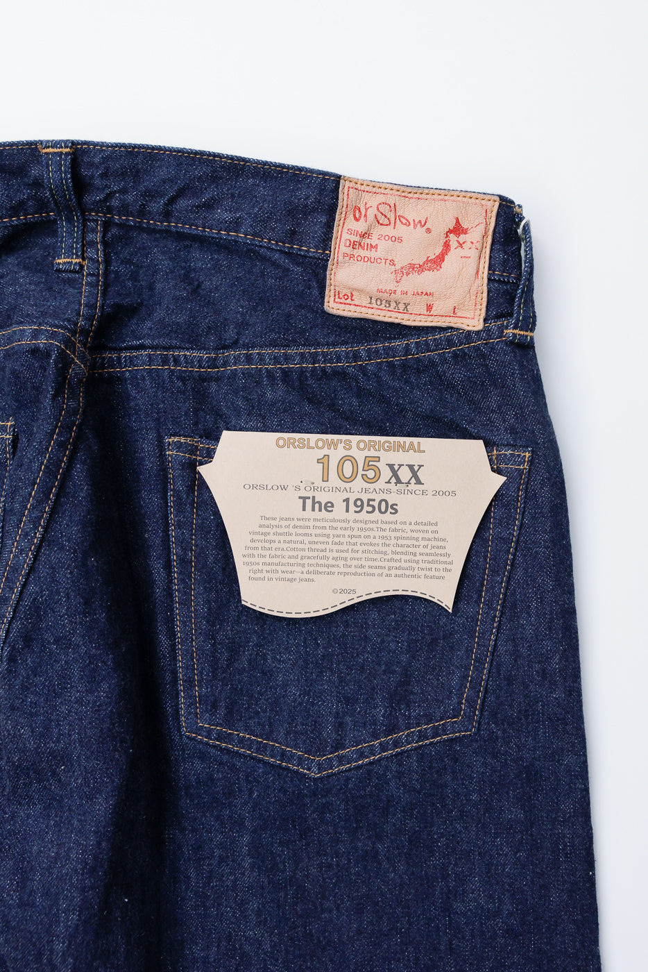 Close-up of orSlow 105XX selvedge denim, back side, showing leather patch and pocket tag details.