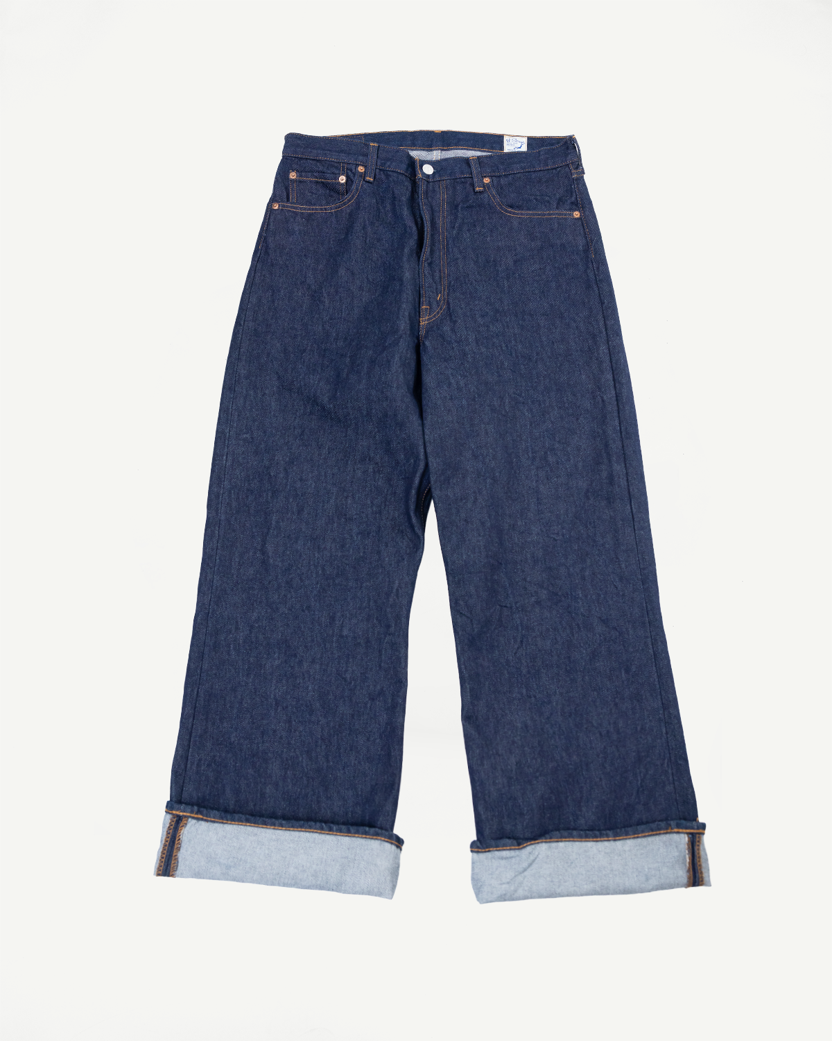 Front view flat lay of dark indigo wide-leg denim jeans with cuffed hems.