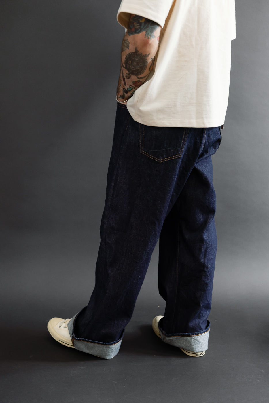 Side view of dark indigo selvedge denim jeans on a male model, 5'9