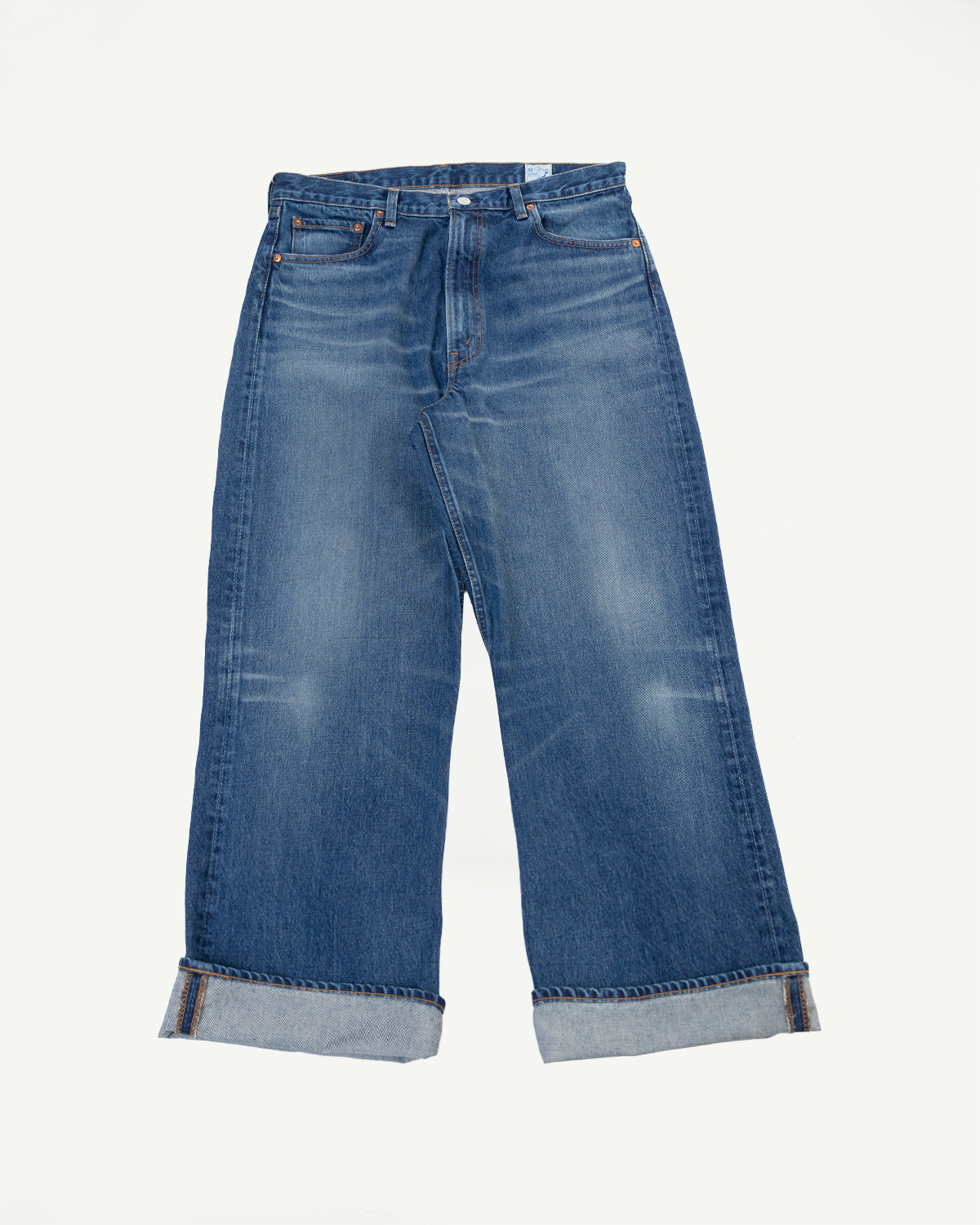 Front view flat lay of wide-leg blue denim jeans with cuffed hems.