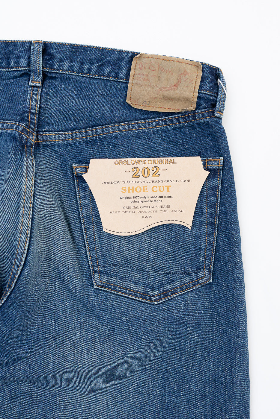 Close-up of the back pocket and leather patch of Orslow's Original 202 Shoe Cut selvedge denim jeans.