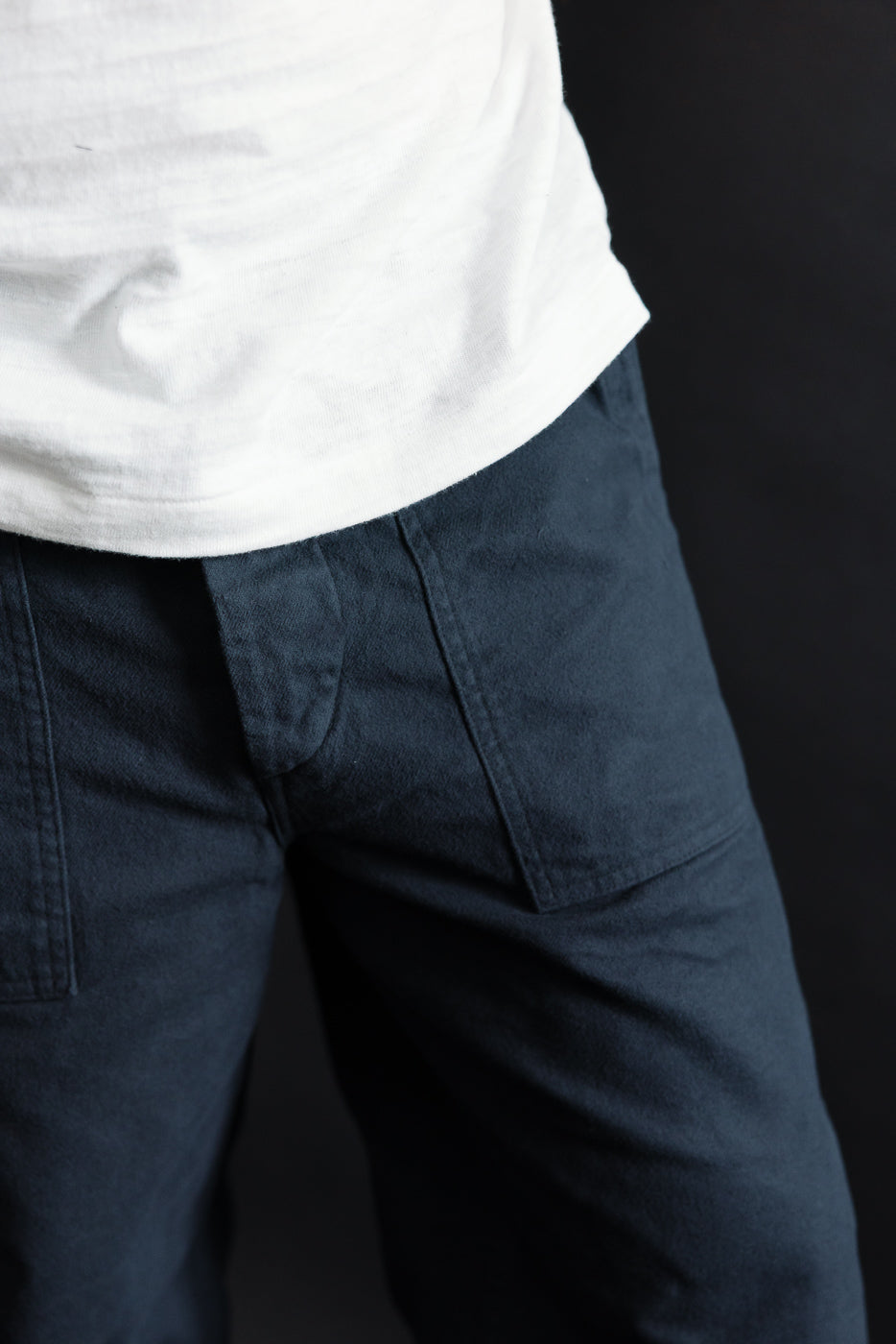 Close-up front view of orSlow dark navy brushed flannel fatigue pants on male model, showing textured fabric and pocket detail.