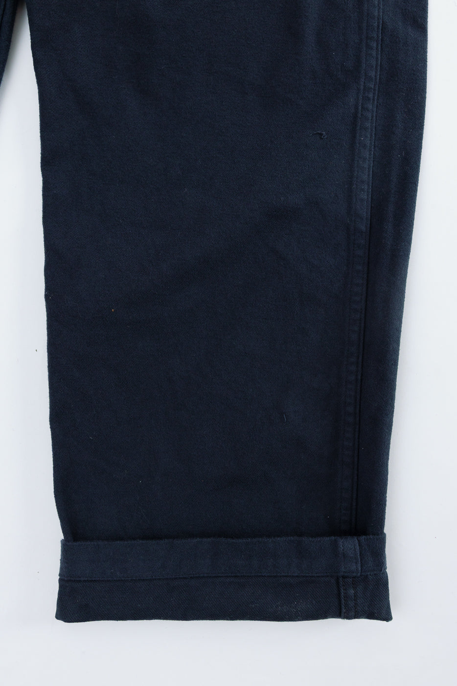 Close-up of orSlow dark navy brushed flannel fatigue pants leg hem, front view, fabric detail