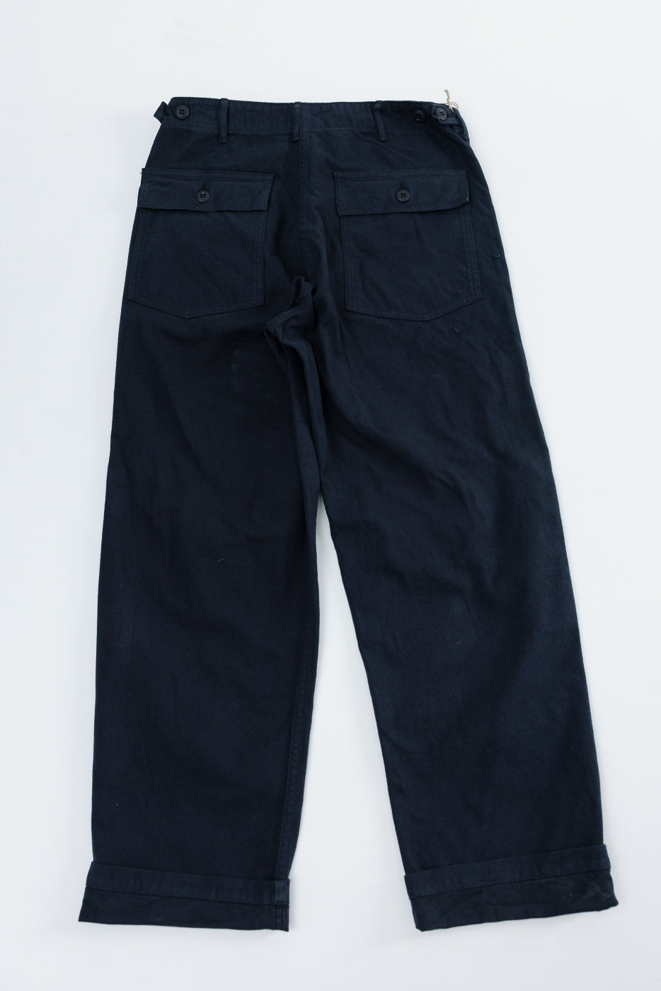 Flat lay back view of orSlow brushed flannel navy fatigue pants, showing buttoned back pockets.
