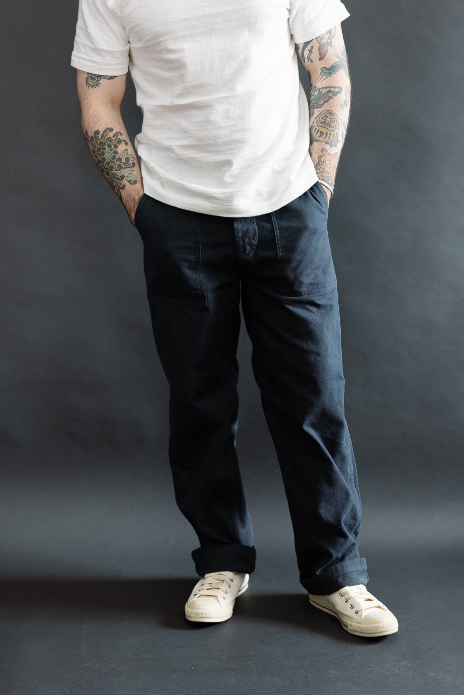 Front view, full body shot of male model 5'9 165lbs athletic build wearing orSlow dark navy brushed flannel fatigue pants, hands in pockets, showcasing standard fit from Dant contemporary casual apparel.