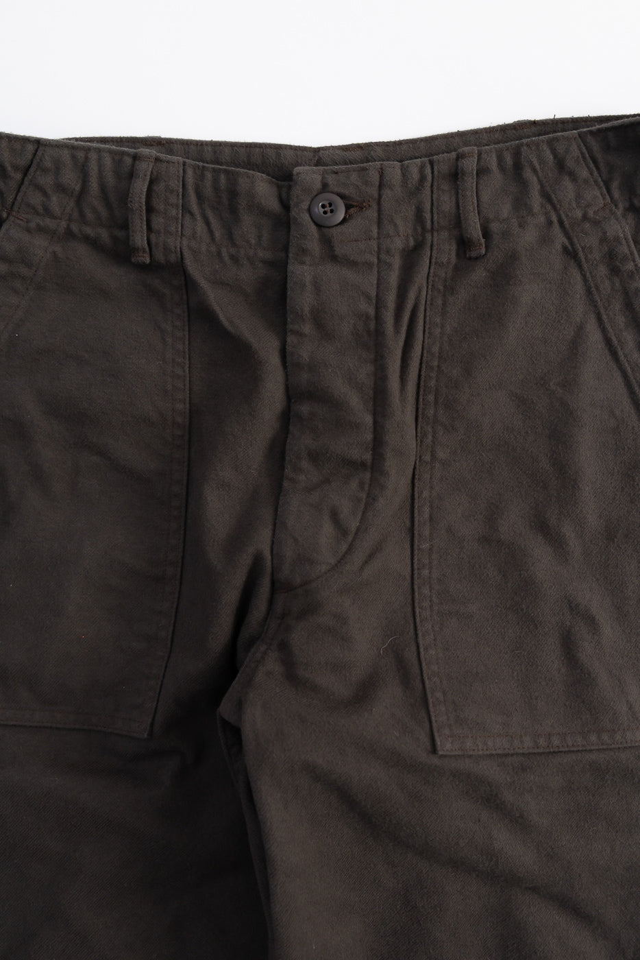 Close-up front view of Orslow coffee brown fatigue pants, showing waistband, button, front pockets, and brushed flannel fabric texture.