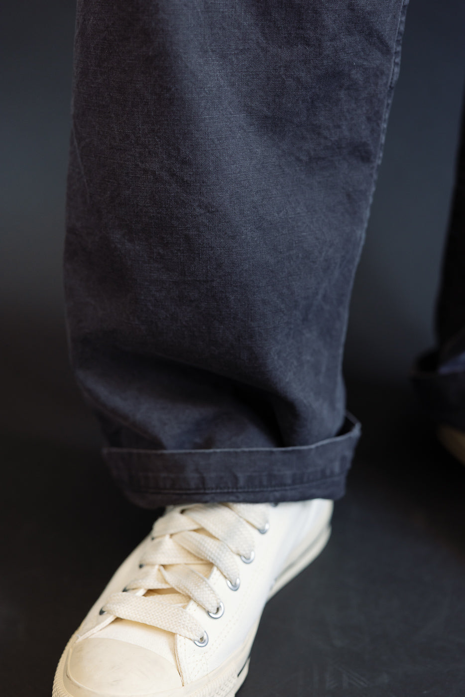 Close-up of the 01-5103-M61K Duck Canvas Summer Fatigue Pants in black, showcasing rolled hems and paired with white canvas sneakers, highlighting the pants' lightweight duck canvas texture and wide, roomy fit.