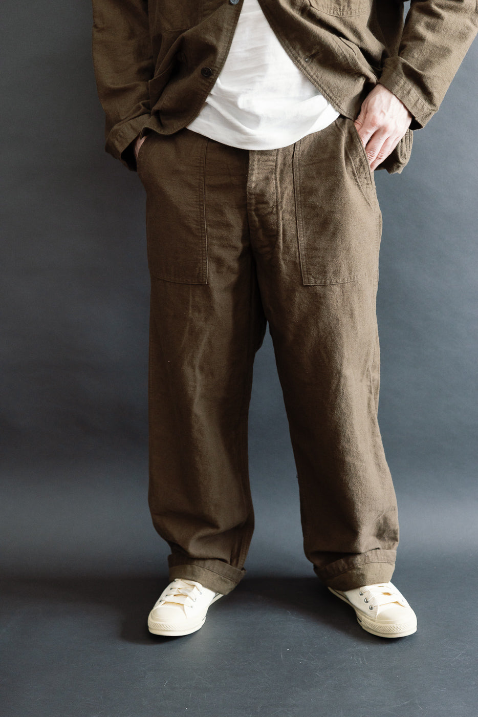 Front view, mid-close-up of orSlow coffee brown fatigue pants on male model, 5'9