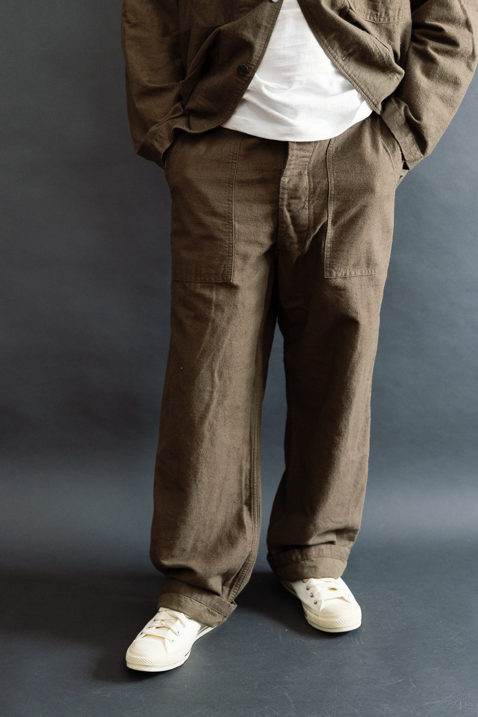 Front view close-up of men's Orslow coffee brown fatigue pants, cotton linen moleskin, relaxed fit, worn by 5'9