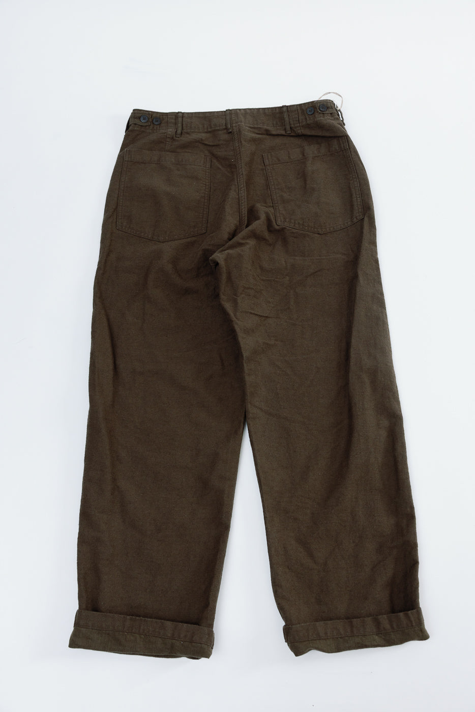 Back view flat lay of orSlow coffee brown fatigue pants in cotton linen moleskin, showing rear pockets and button details, Dant contemporary casual apparel.
