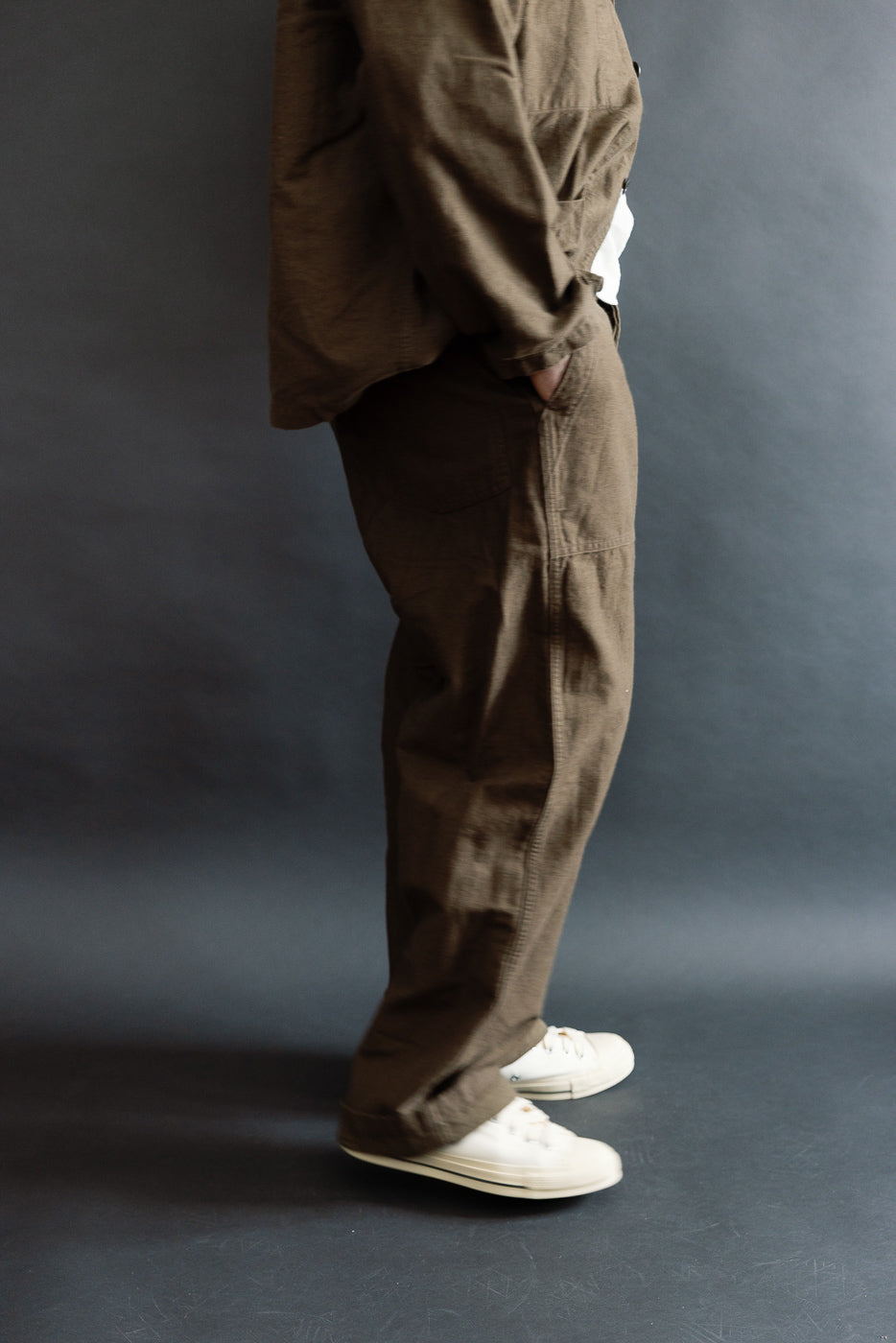 Side view close-up of men's Orslow coffee brown fatigue pants, relaxed fit, shown on 5'9