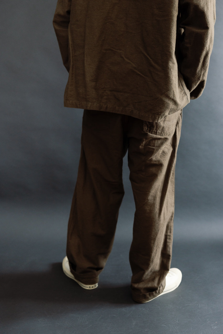 Rear close-up of coffee brown Orslow fatigue pants on male model, 5'9