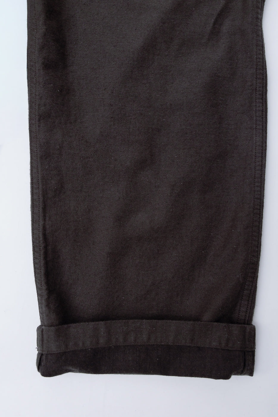 Close-up of orSlow fatigue pants leg hem, charcoal gray cotton linen moleskin, front view