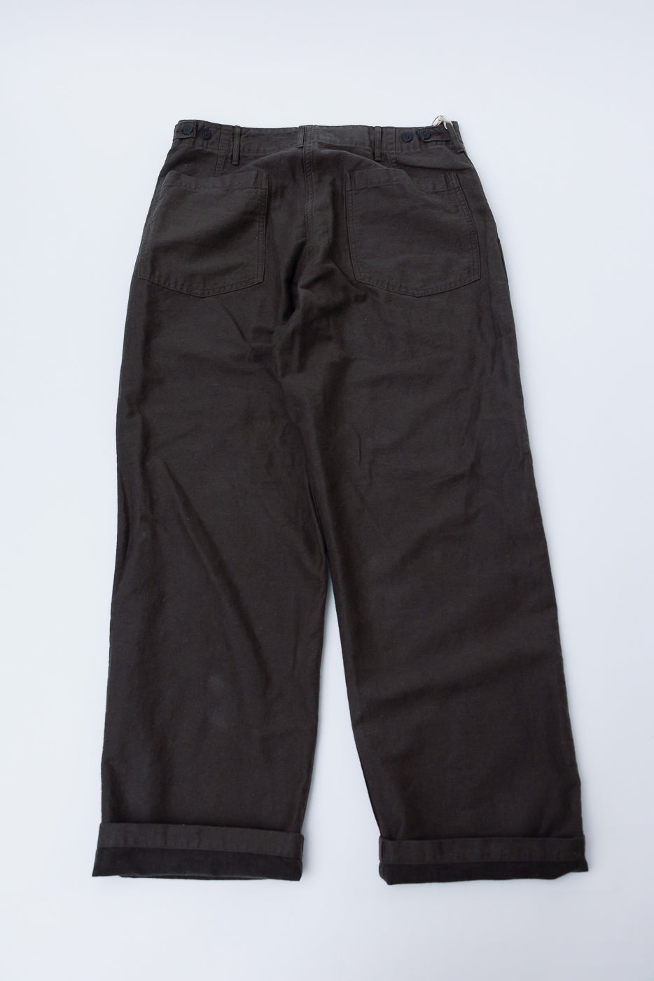 Flat lay of Orslow charcoal gray fatigue pants, back side, showing rear pockets and cuffed hems.
