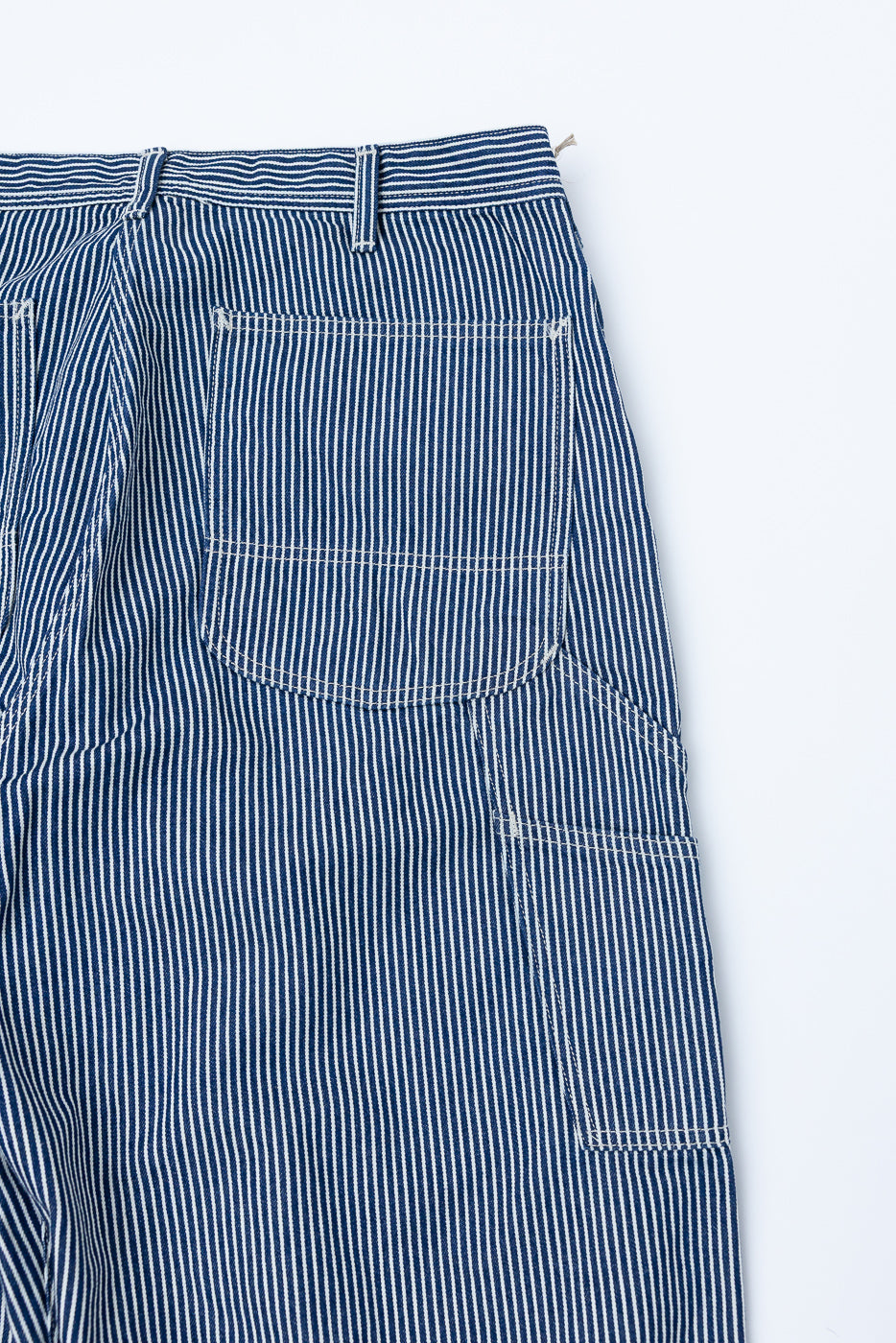 Close-up of back right side of indigo ecru hickory striped painter pants showing pocket details