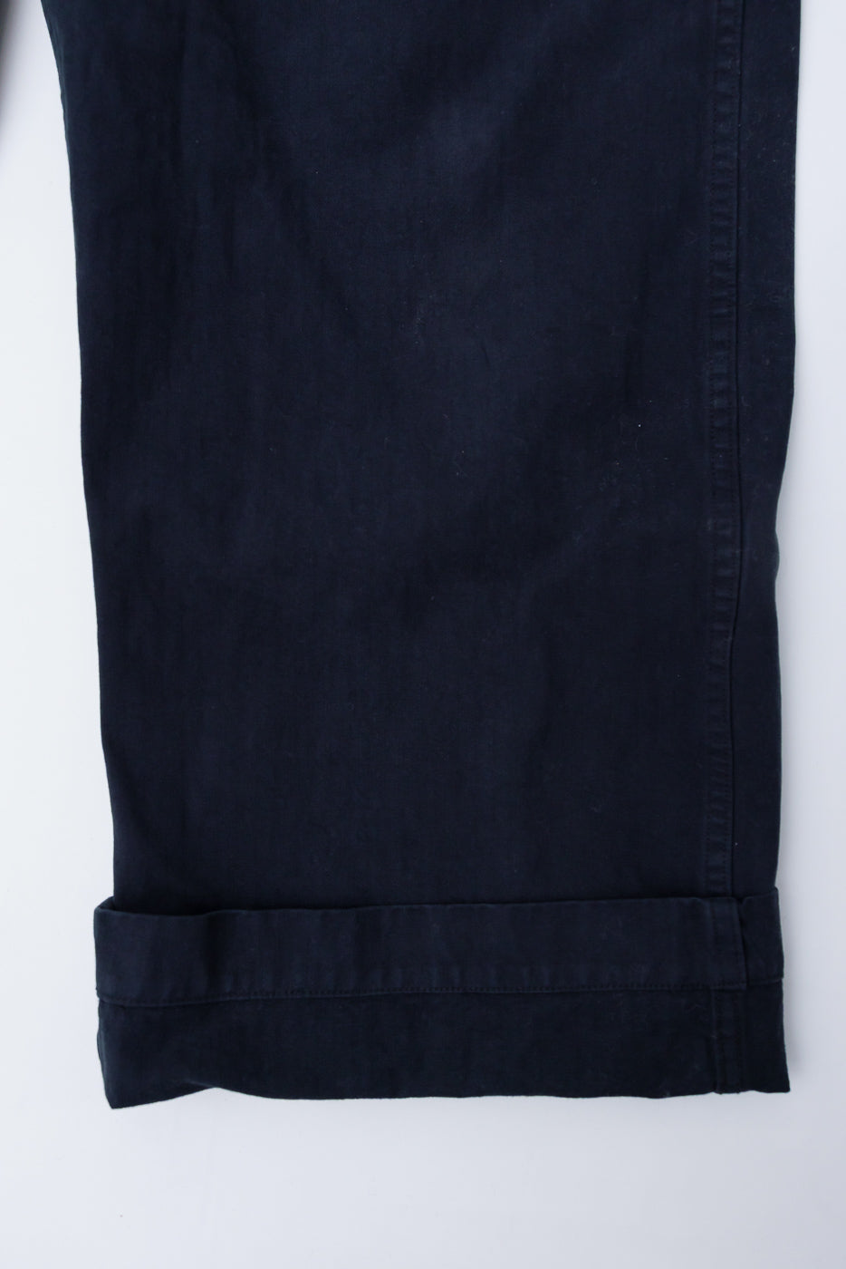 Close-up of orSlow black herringbone wide fit trousers hem, front left leg detail.