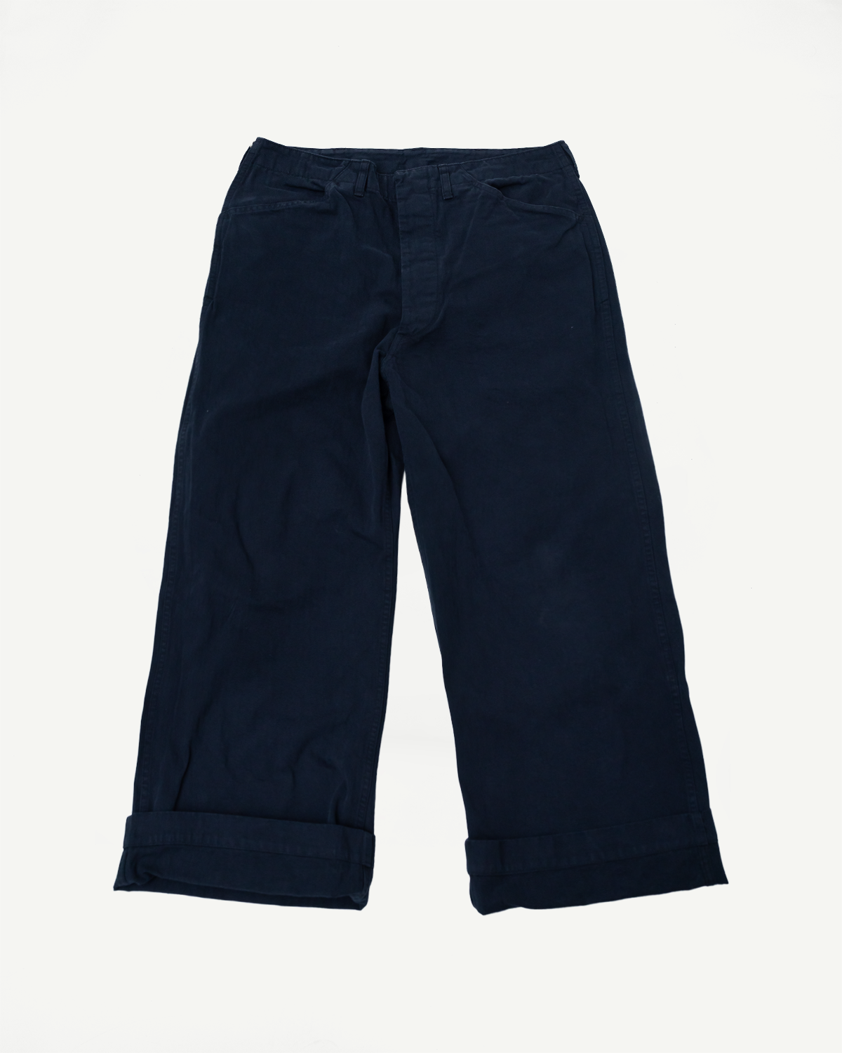 Flat lay front view of black Orslow USMC herringbone wide fit utility trousers, rolled cuffs