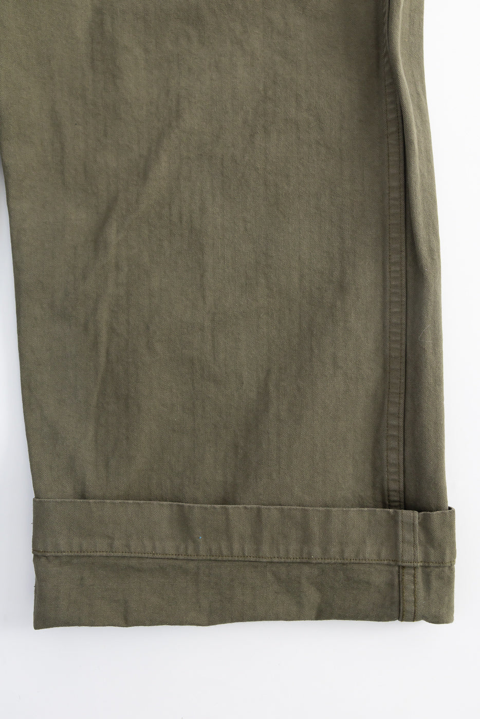 Close-up of orSlow USMC herringbone utility trousers hem in dark olive, right leg, fabric detail