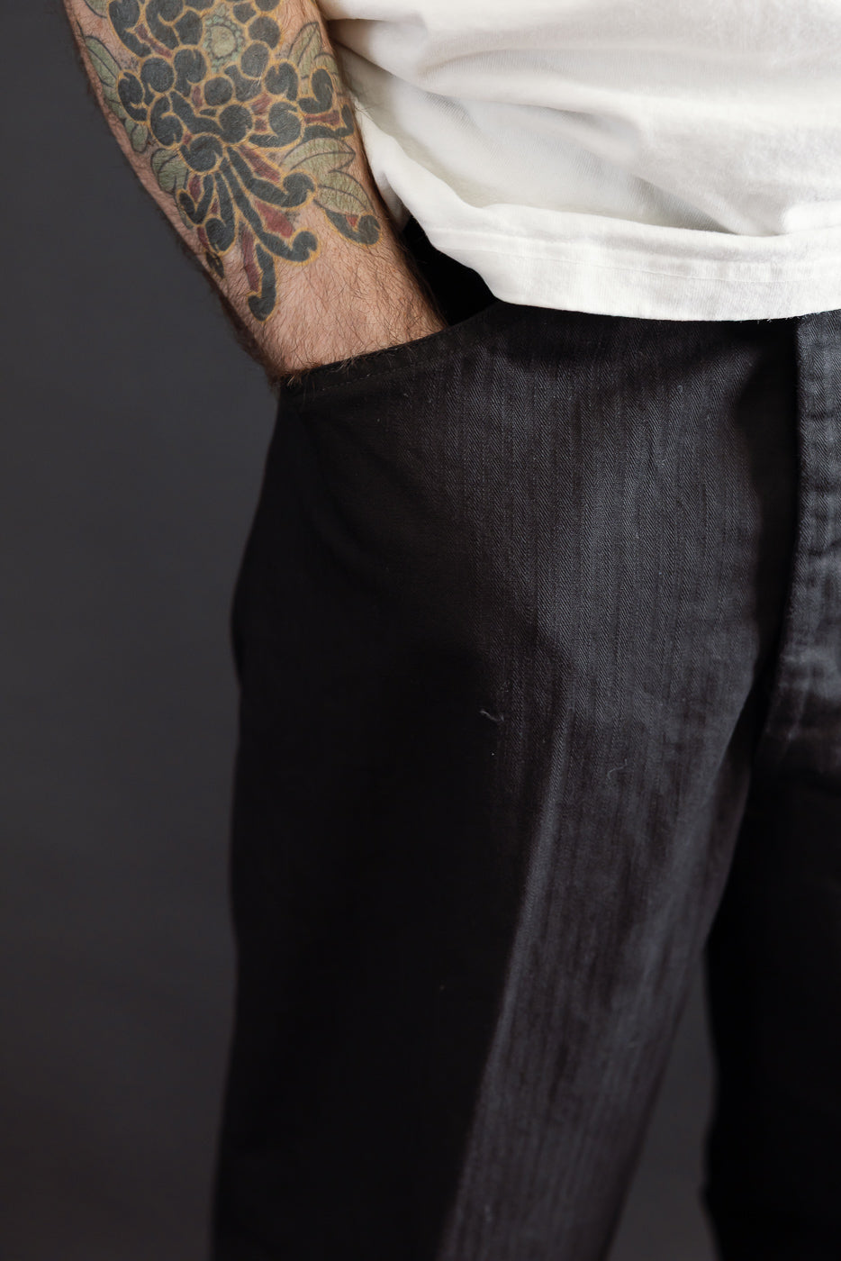 Close-up side view of black trousers on a male model, 5'9