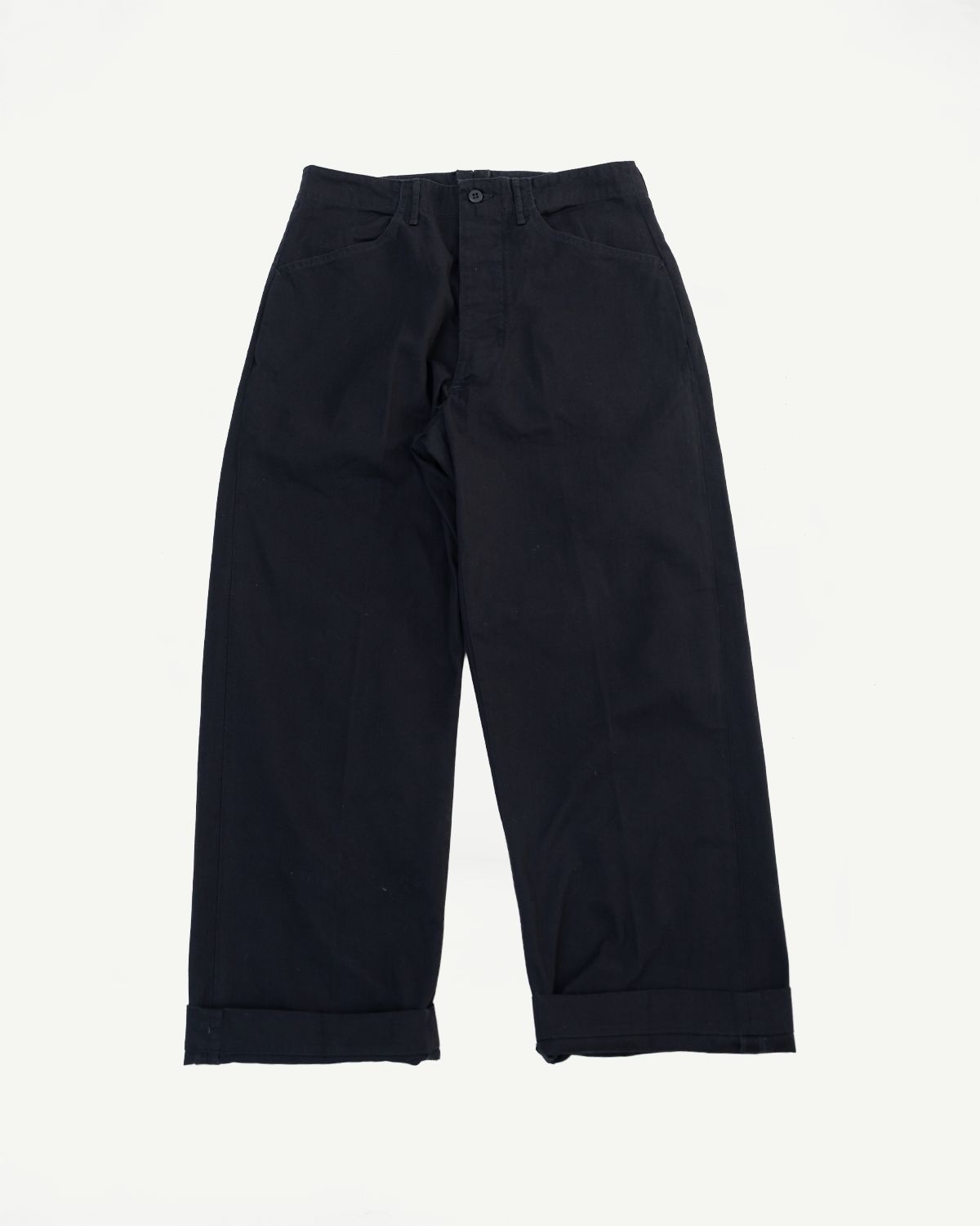 Front view flat lay of black wide-leg trousers with cuffed hems on a white background.