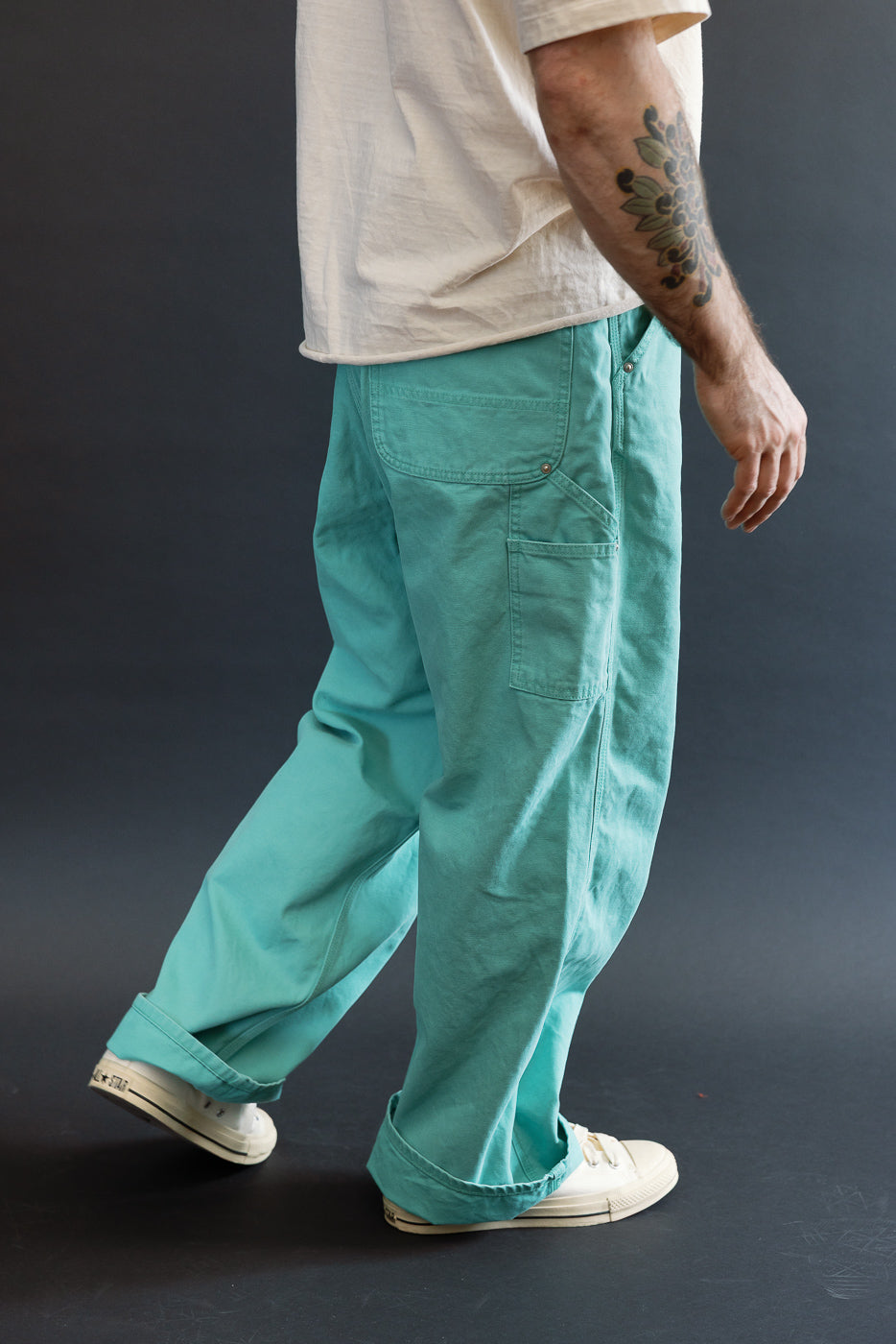 01-5328-39SK - Dad's Fit Painter's Pants Canvas - Turquoise: Loose-fit sea-foam-green trousers with side utility pocket, rolled cuffs, and brass UFO rivet detail, paired with off-white canvas sneakers.