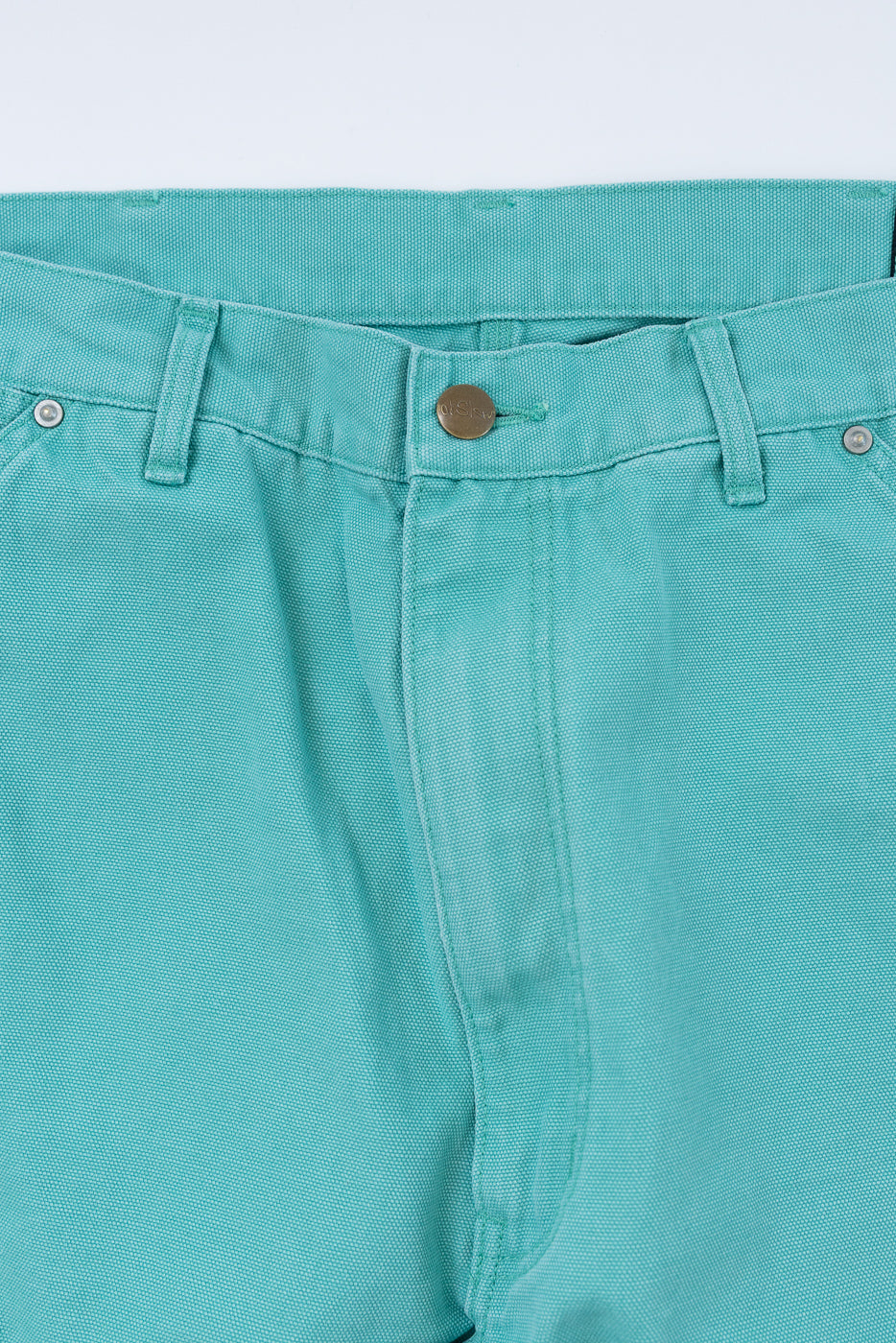 Close-up of the 01-5328-39SK - Dad's Fit Painter's Pants Canvas in Turquoise, highlighting the waistband, belt loops, metal button closure, and brass UFO rivets, showcasing the aged duck cotton canvas texture.