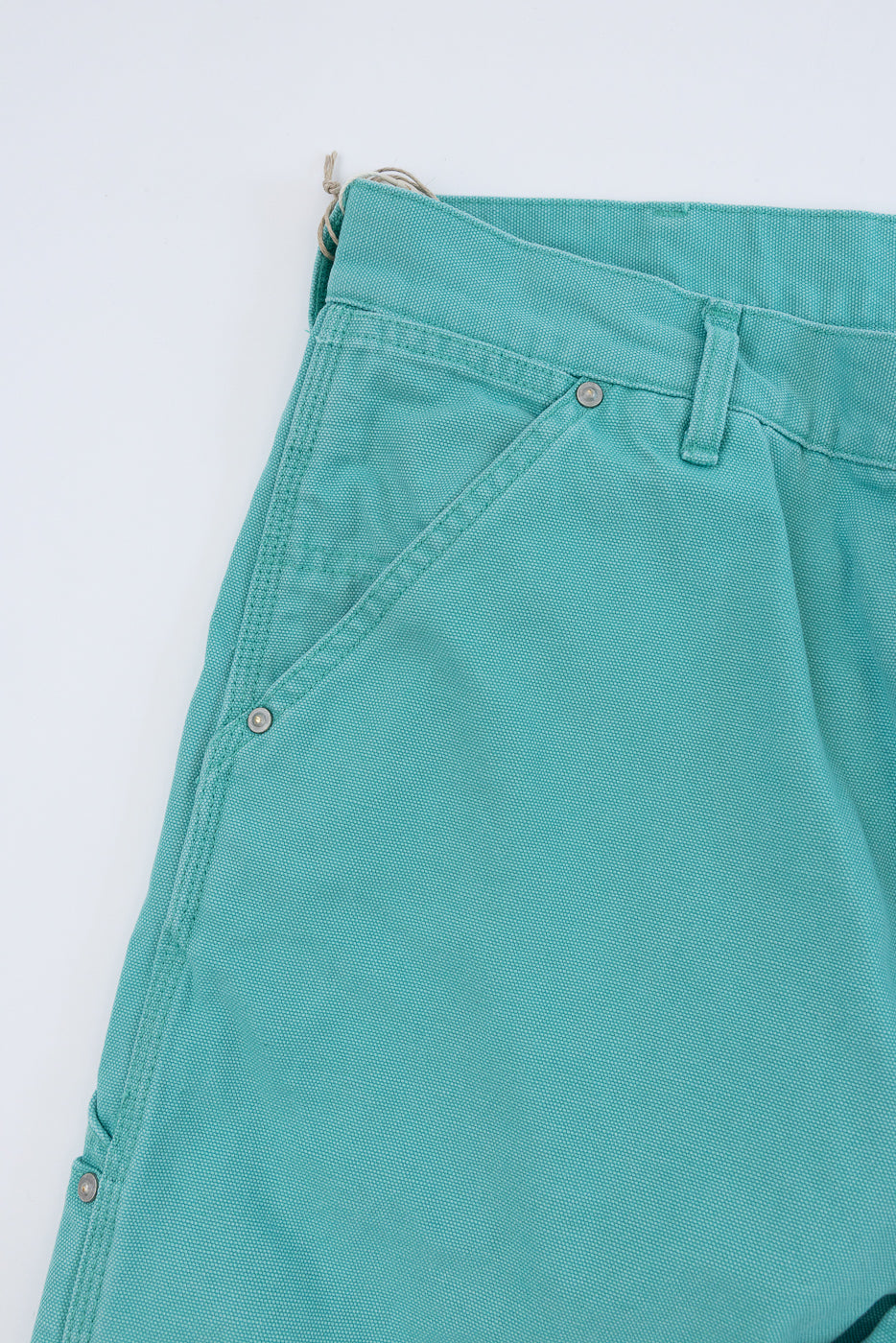 01-5328-39SK - Dad's Fit Painter's Pants Canvas - Turquoise, showcasing a close-up of the teal waistband with belt loop, metal rivet-adorned pocket, and pant leg, embodying tactile, aged canvas texture.