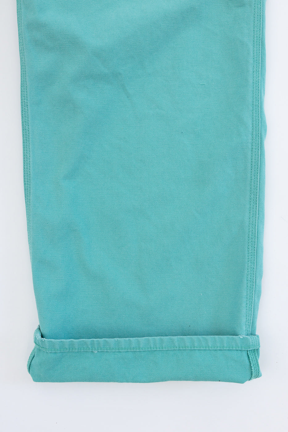 Turquoise Dad's Fit Painter's Pants with rolled cuffs, showcasing the aged canvas texture and brass UFO rivet detail.