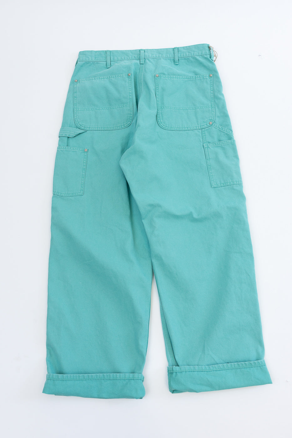 01-5328-39SK - Dad's Fit Painter's Pants Canvas - Turquoise, showcasing loose-fit, teal trousers with cuffed legs, large patch pockets, and custom brass rivet details, crafted from aged duck cotton canvas.