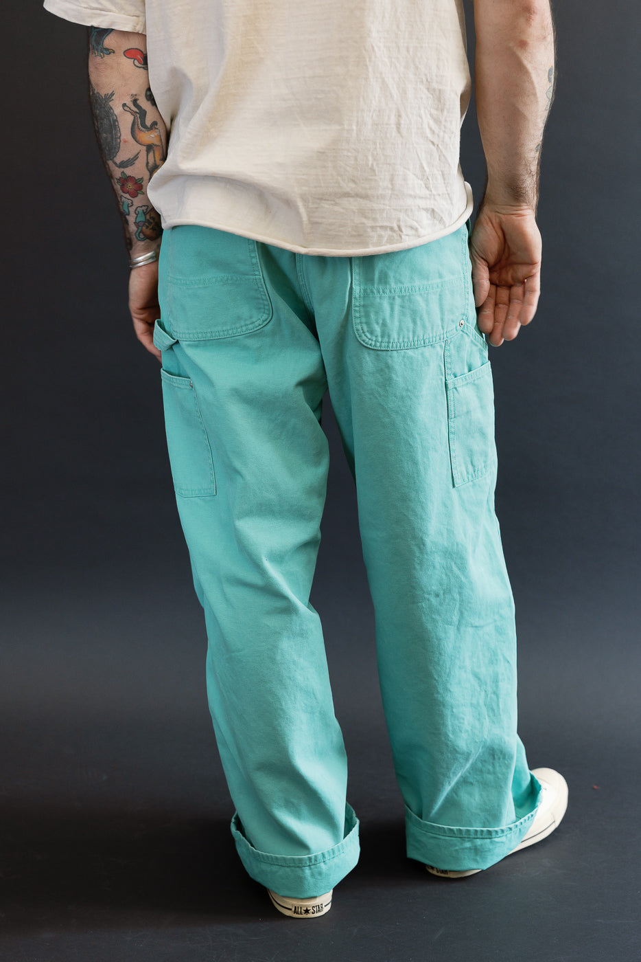 01-5328-39SK - Dad's Fit Painter's Pants Canvas - Turquoise, featuring loose-fit, sea-foam green cargo pants with rolled cuffs, patch pockets, and brass rivet detail, styled with white low-top sneakers.