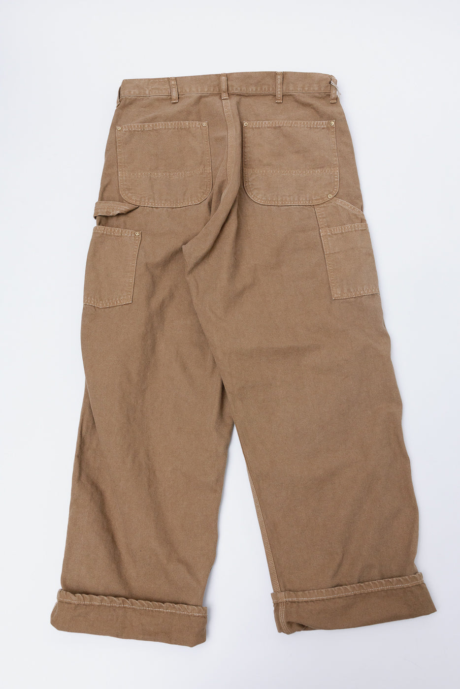 Flat lay of orSlow Dad's Fit brown canvas painter pants, back view, showing pocket details.