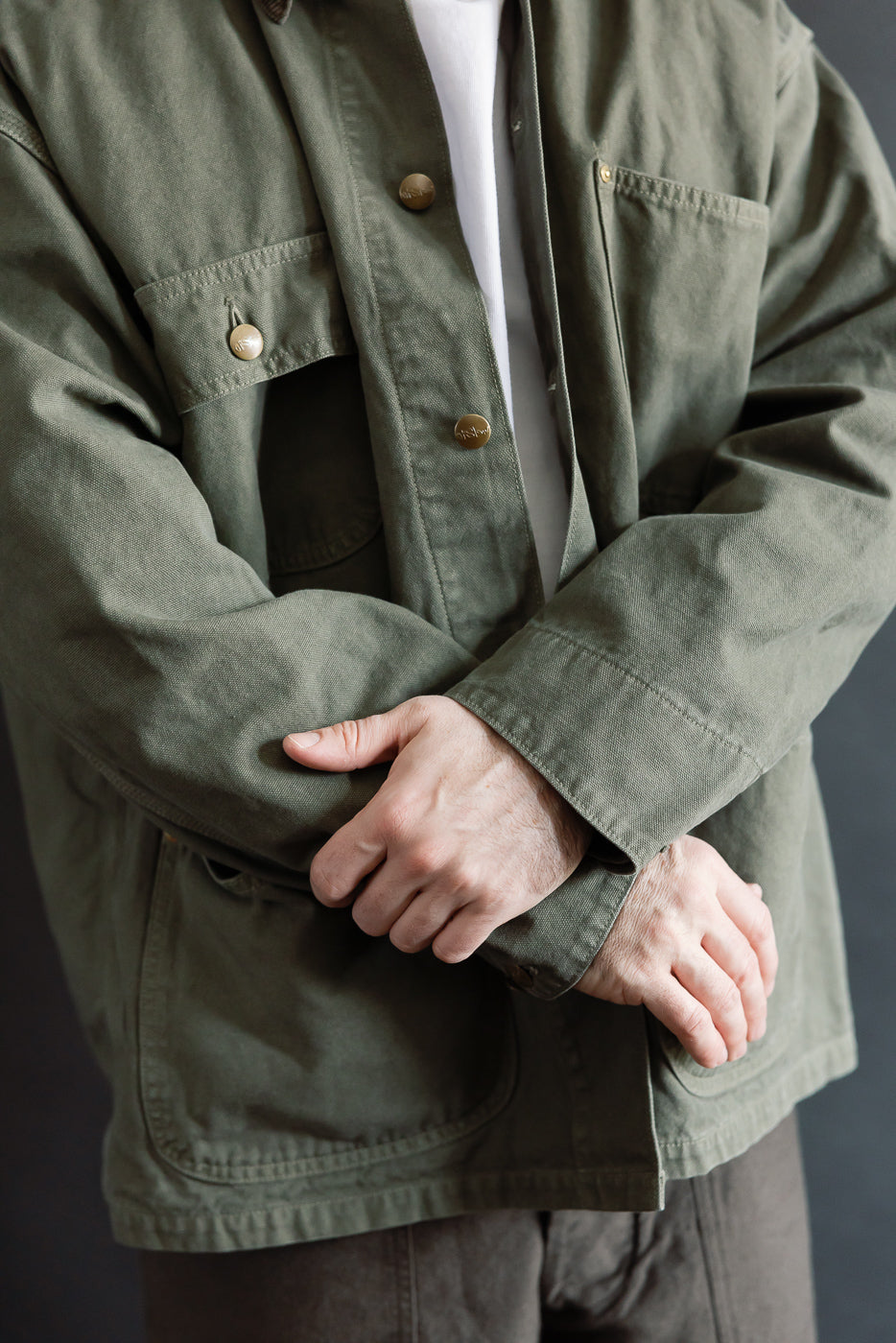 Close-up front of orSlow army green coverall jacket on male model, 5'9