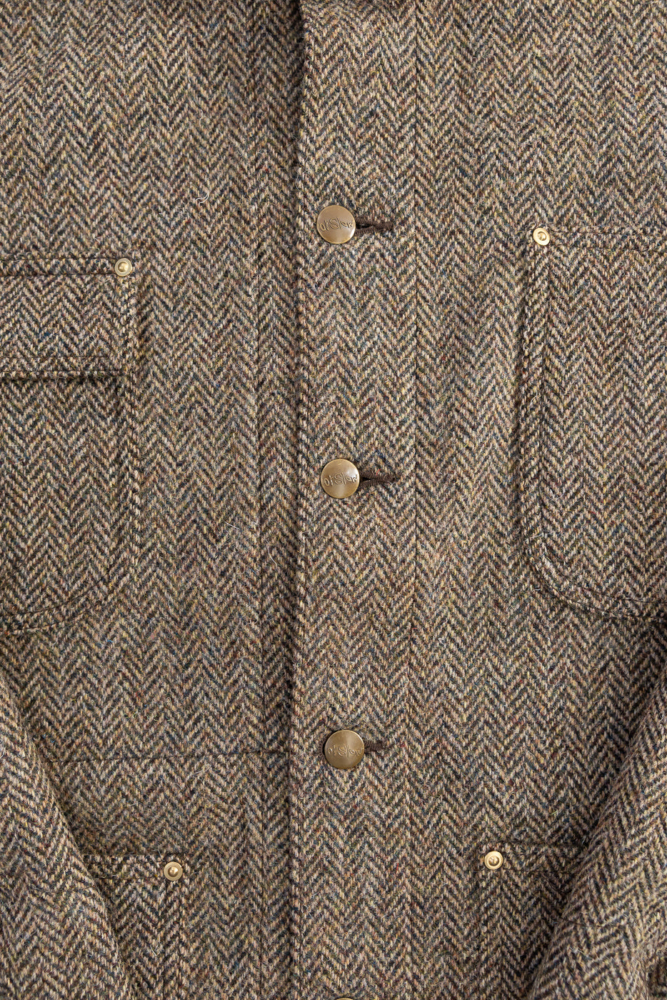 Close-up front detail of Orslow Harris Tweed coverall jacket in khaki, showing herringbone texture, metal buttons, and flap pockets.