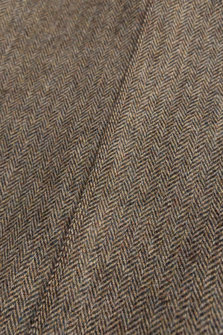 Close-up detail of orSlow Harris Tweed coverall jacket khaki herringbone fabric texture