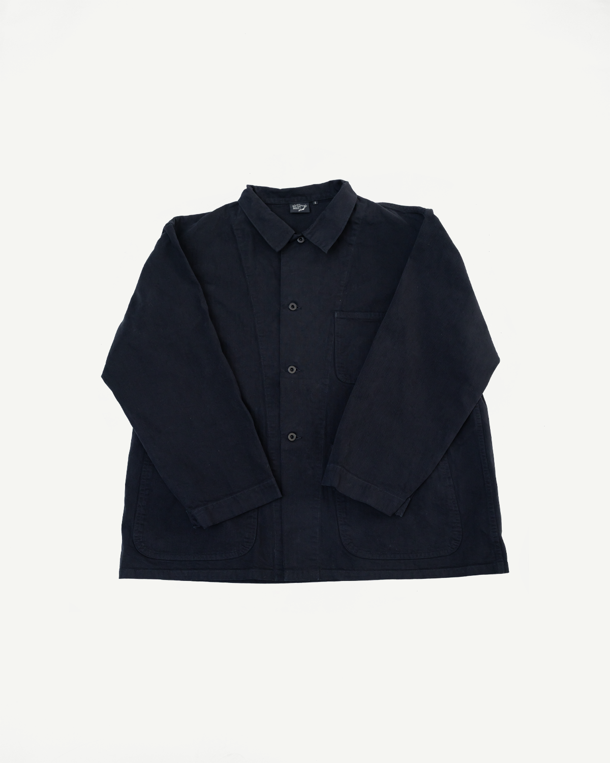 Front view flat lay of a navy blue long-sleeve button-up chore jacket with patch pockets.
