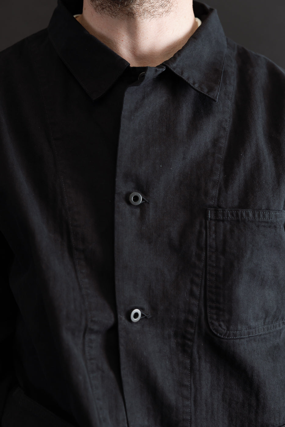Close-up front view of a black linen shirt on a 5'9