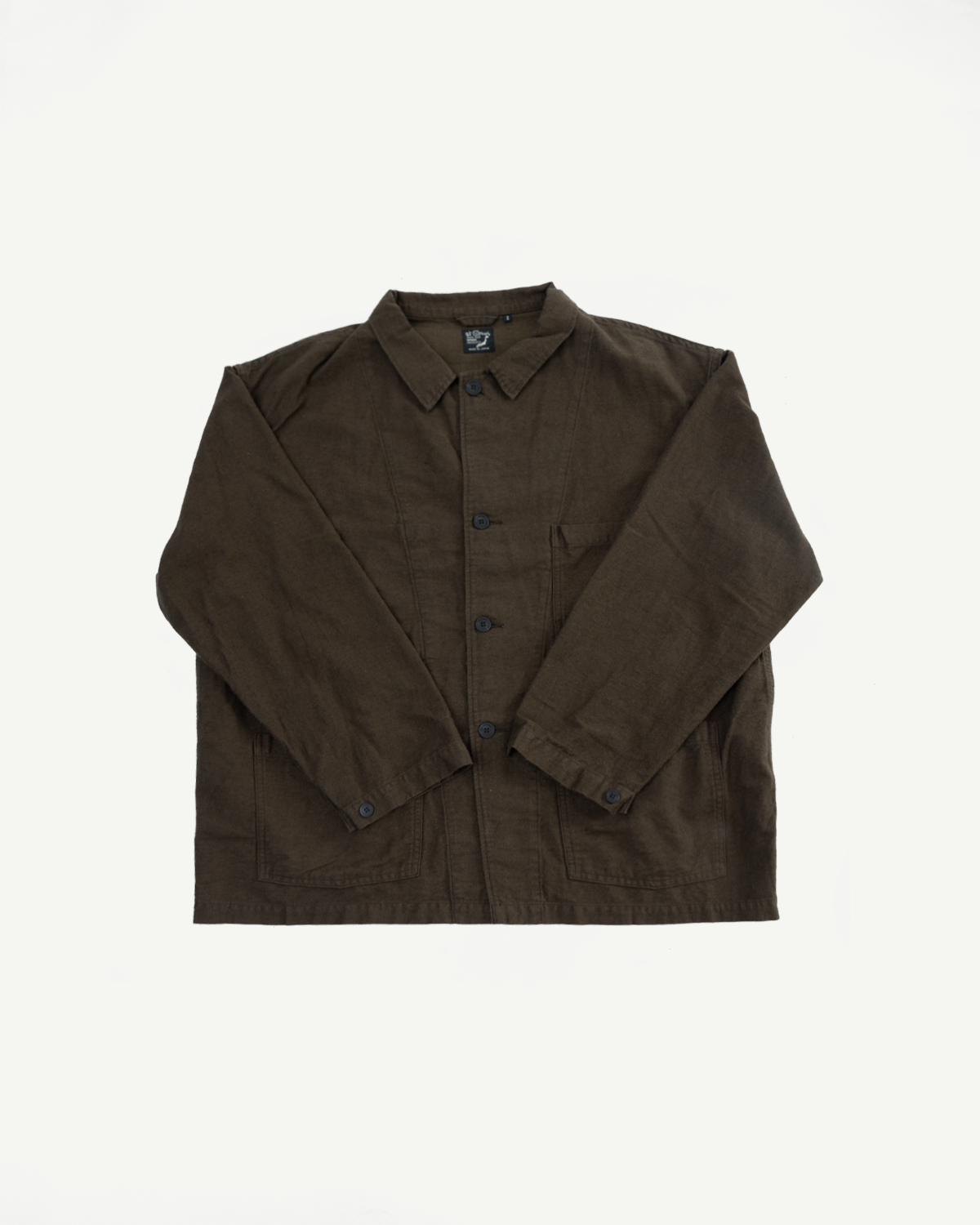 Flat lay front view of Orslow moleskin work jacket in coffee brown, button front, collar, visible pockets.