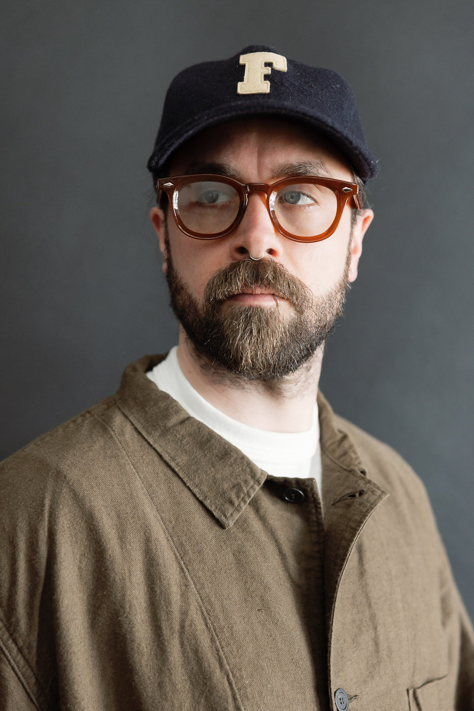 Close-up front view of orSlow coffee brown moleskin work jacket, collar and chest details on male model, 5'9