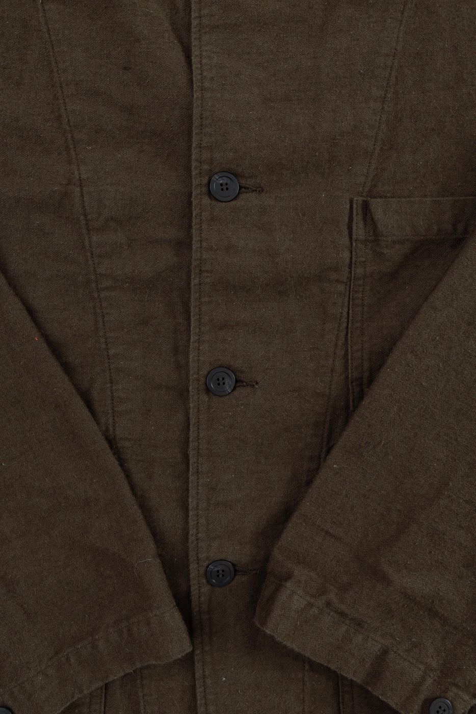 Close-up front of coffee brown moleskin work jacket, showing buttons and chest pocket