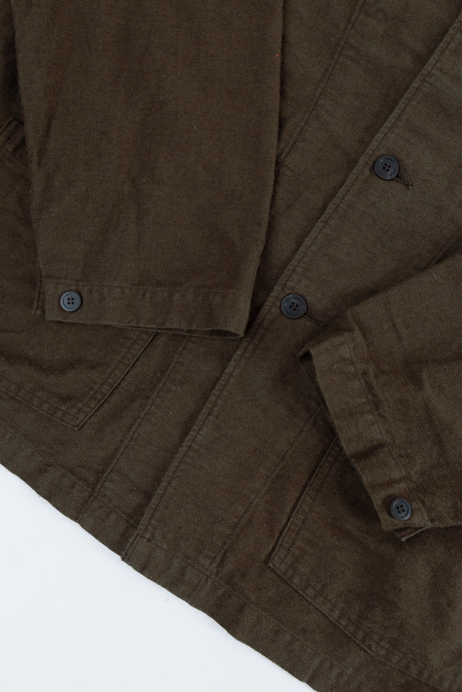 Close-up front of orSlow coffee brown moleskin work jacket showing button cuff, pockets, textured fabric at Dant