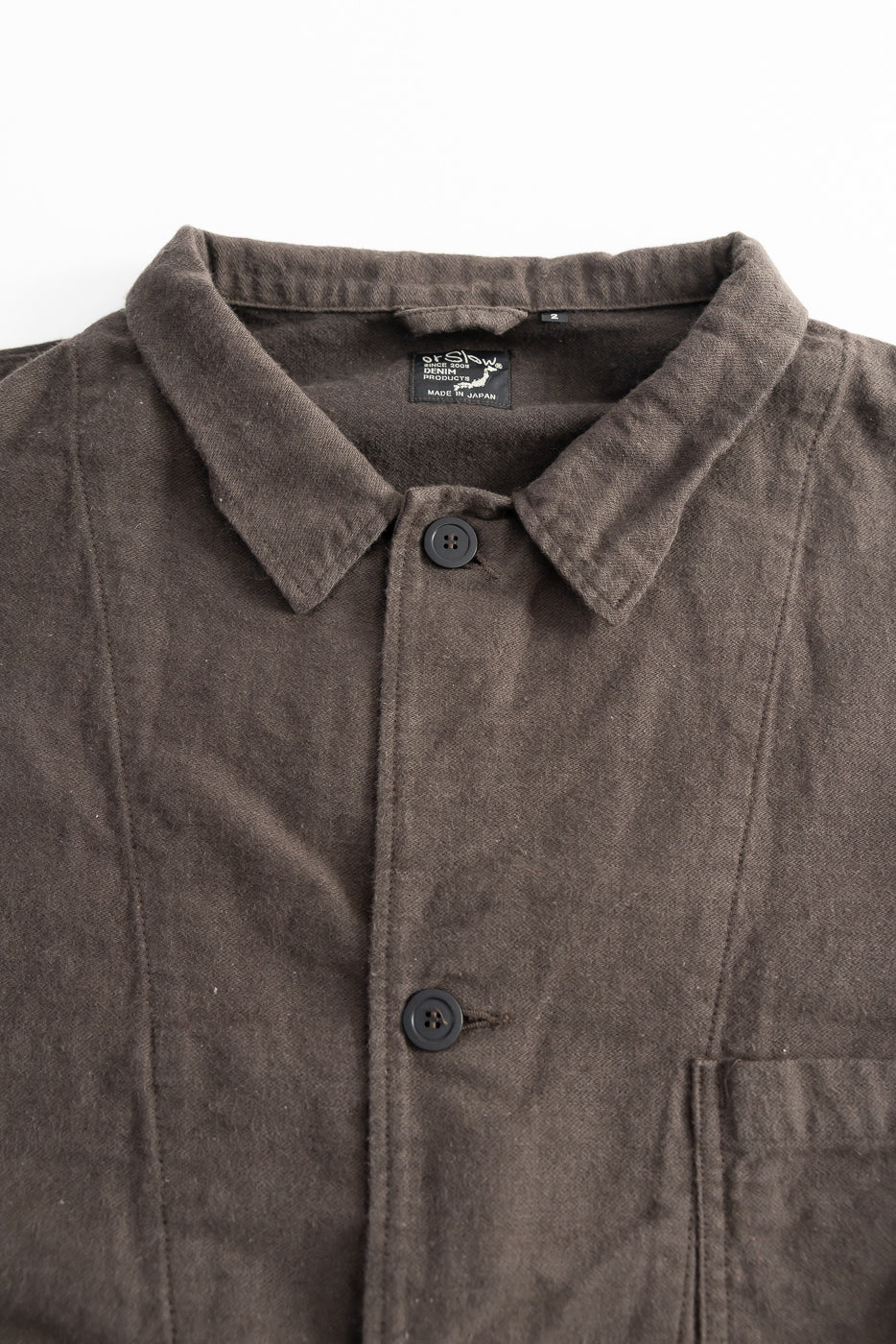 Close-up front view of orSlow charcoal moleskin work jacket showing collar, buttons, chest pocket, and fabric texture.